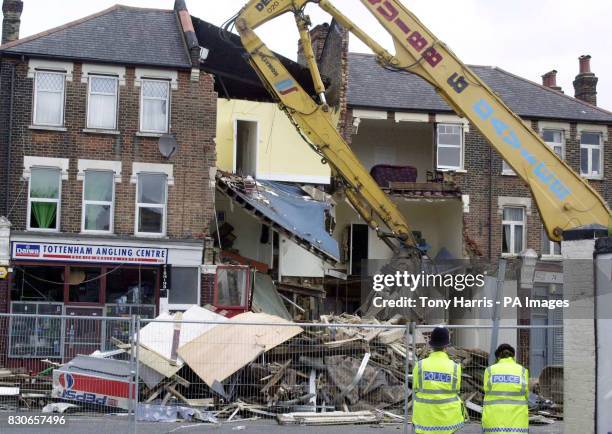 Mechanical digger help clear rubble from the collapsed three-storey building in White Hart Lane, north London. The building, collapsed soon after 8am...