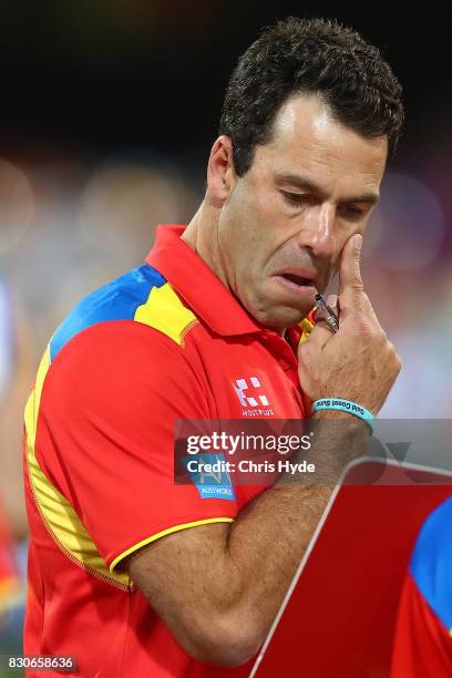 Suns interim Coach Dean Solomon talks to players during the round 21 AFL match between the Brisbane Lions and the Gold Coast Suns at The Gabba on...