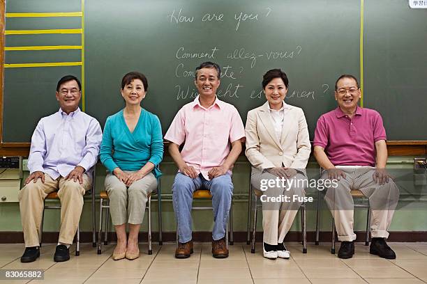 middle-aged students in class - tefl stock pictures, royalty-free photos & images