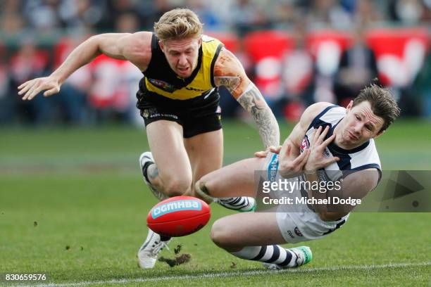 Patrick Dangerfield of the Cats drop a mark against Nathan Broad of the Tigers during the round 21 AFL match between the Geelong Cats and the...