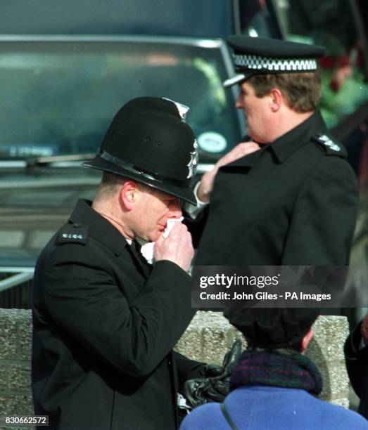 Policeman is overcome with emotion outside The Sacred Heart Church, Kirby, where the funeral service for two year old murder victim, James Bulger,...