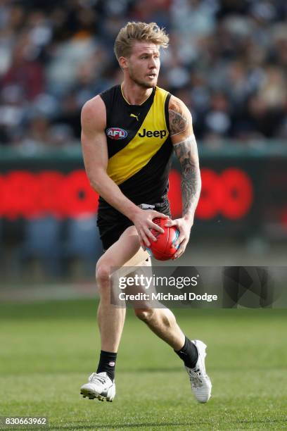 Nathan Broad of the Tigers runs with the ball during the round 21 AFL match between the Geelong Cats and the Richmond Tigers at Simonds Stadium on...