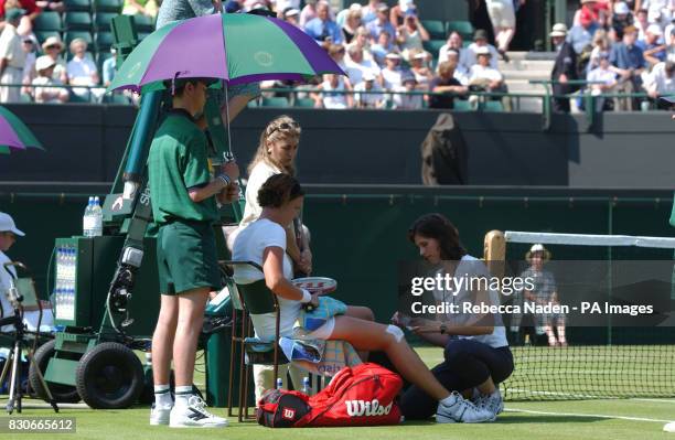 S Lindsay Davenport recieves treatment during her game against Slovakia's Martina Sucha during the First Round match of the Lawn Tennis Championships...