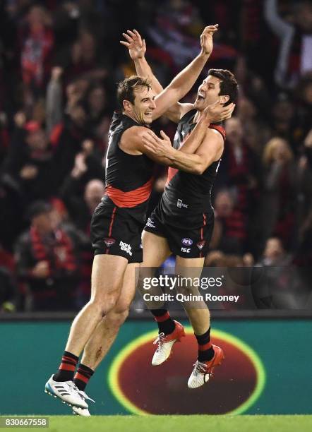 Jobe Watson of the Bombers is congratulated by Ben Howlett after kicking a goal during the round 21 AFL match between the Essendon Bombers and the...