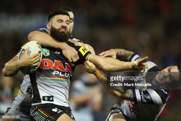 Josh Mansour of the Panthers is tackled by Kane Linnett of the Cowboys during the round 23 NRL match between the Penrith Panthers and the North...