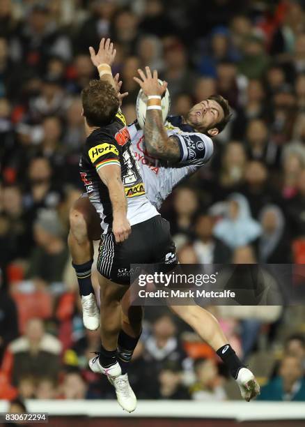 Kyle Feldt of the Cowboys takes a high ball ahead of Matt Moylan of the Panthers during the round 23 NRL match between the Penrith Panthers and the...