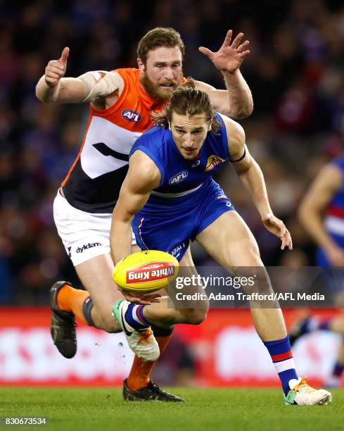 Marcus Bontempelli of the Bulldogs is tackled by Dawson Simpson of the Giants during the 2017 AFL round 21 match between the Western Bulldogs and the...