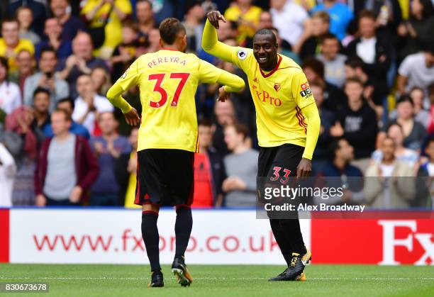 Stefano Okaka of Watford celebrates scoring his sides first goal with Roberto Pereyra of Watford during the Premier League match between Watford and...