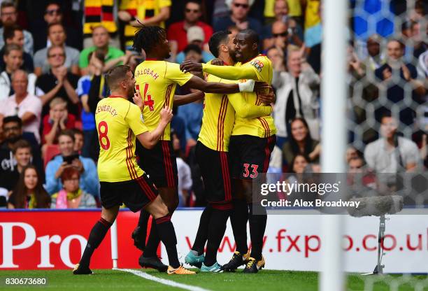 Stefano Okaka of Watford celebrates scoring his sides first goal with his Watford team mates during the Premier League match between Watford and...