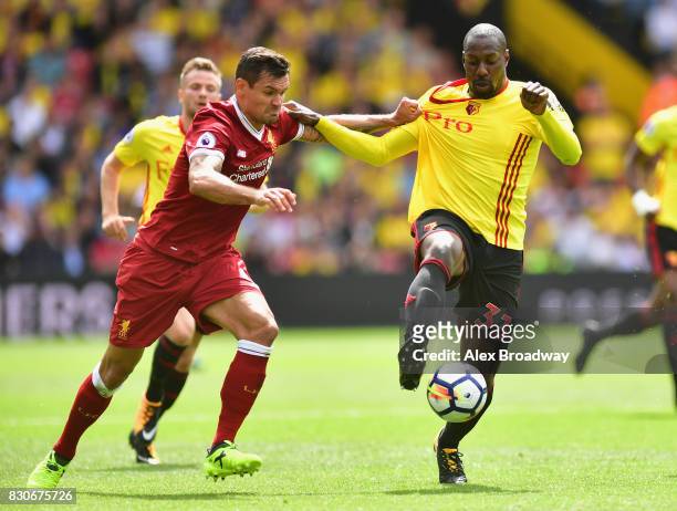 Dejan Lovren of Liverpool and Stefano Okaka of Watford battle for possession during the Premier League match between Watford and Liverpool at...