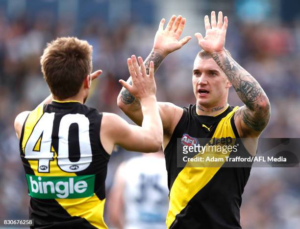 Dustin Martin of the Tigers congratulates Dan Butler of the Tigers on a goal during the 2017 AFL round 21 match between the Geelong Cats and the...