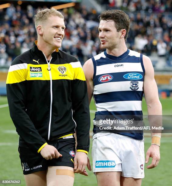 An injured Josh Caddy of the Tigers chats to former Cats teammate Patrick Dangerfield during the 2017 AFL round 21 match between the Geelong Cats and...