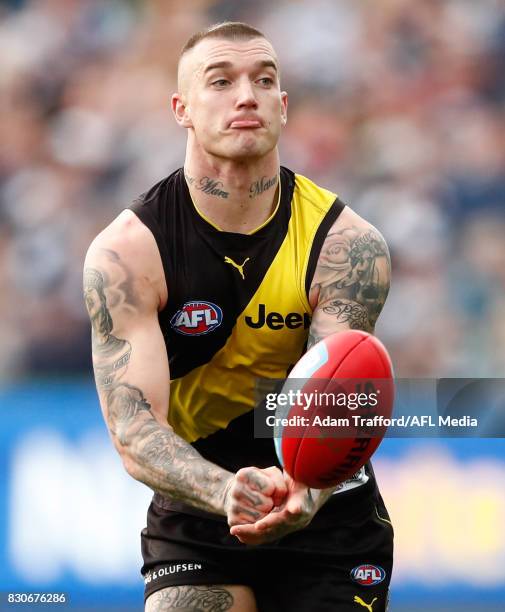 Dustin Martin of the Tigers handpasses the ball during the 2017 AFL round 21 match between the Geelong Cats and the Richmond Tigers at Simonds...