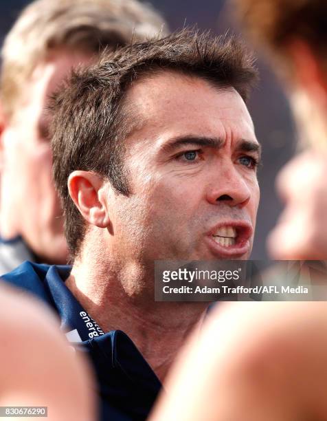 Chris Scott, Senior Coach of the Cats addresses his players during the 2017 AFL round 21 match between the Geelong Cats and the Richmond Tigers at...