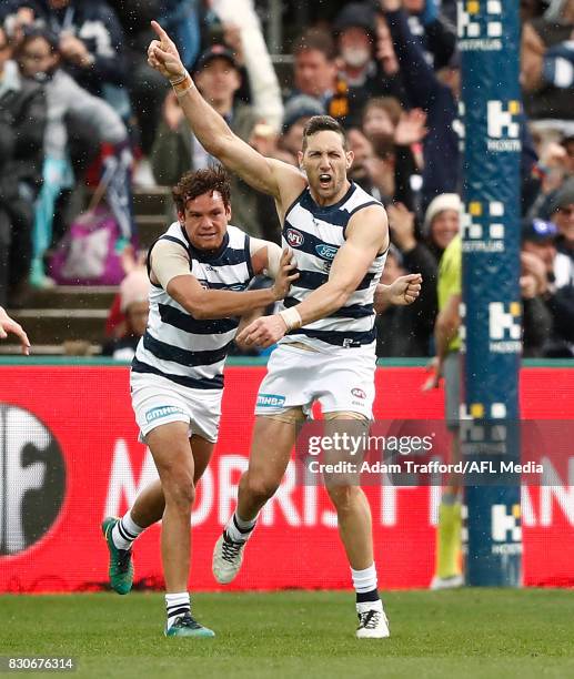 Harry Taylor of the Cats celebrates a last quarter goal with Steven Motlop of the Cats during the 2017 AFL round 21 match between the Geelong Cats...