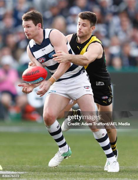 Patrick Dangerfield of the Cats is tackled by Trent Cotchin of the Tigers during the 2017 AFL round 21 match between the Geelong Cats and the...