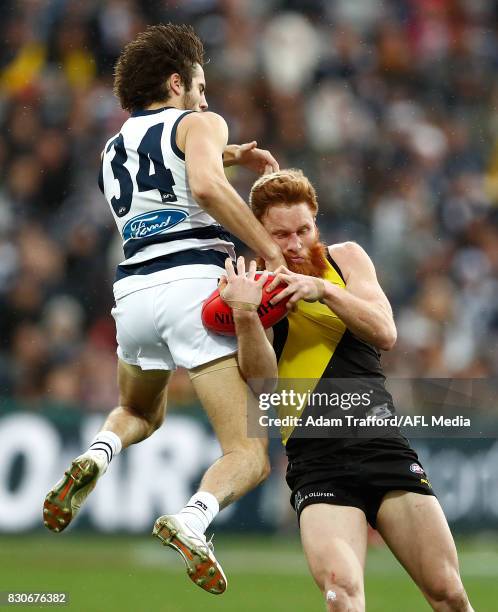 Nick Vlastuin of the Tigers marks the ball ahead of James Parsons of the Cats during the 2017 AFL round 21 match between the Geelong Cats and the...