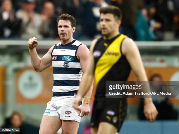 Patrick Dangerfield of the Cats celebrates on the final siren as Trent Cotchin of the Tigers looks dejected during the 2017 AFL round 21 match...