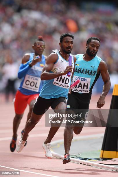 Bahamas' Ramon Miller runs on the shoulder of India's Arokia Rajiv in the men's 4x400m relay athletics event at the 2017 IAAF World Championships at...