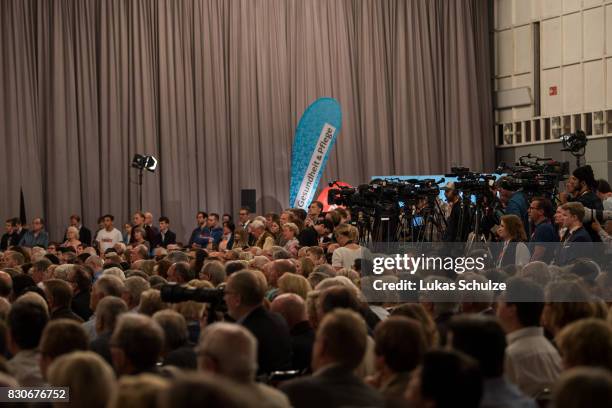 Supporters of the German Christian Democrats listen to the CDU federal election campaign opening rally on August 12, 2017 in Dortmund, Germany....