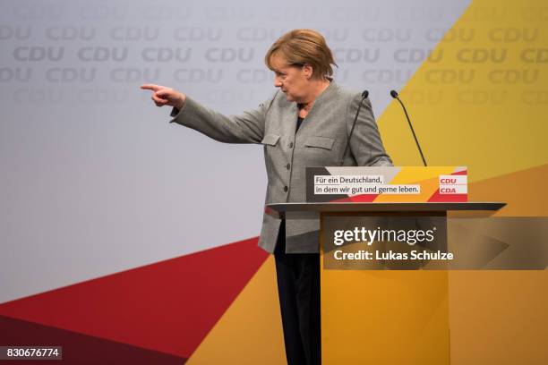 German Chancellor and head of the German Christian Democrats Angela Merkel gestures at the CDU federal election campaign opening rally on August 12,...