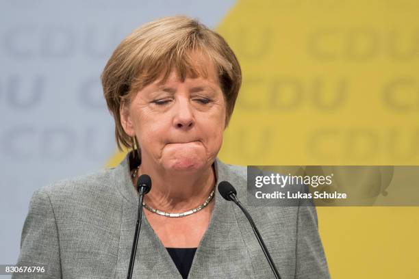 German Chancellor and head of the German Christian Democrats Angela Merkel reacts at the CDU federal election campaign opening rally on August 12,...