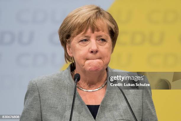 German Chancellor and head of the German Christian Democrats Angela Merkel reacts at the CDU federal election campaign opening rally on August 12,...