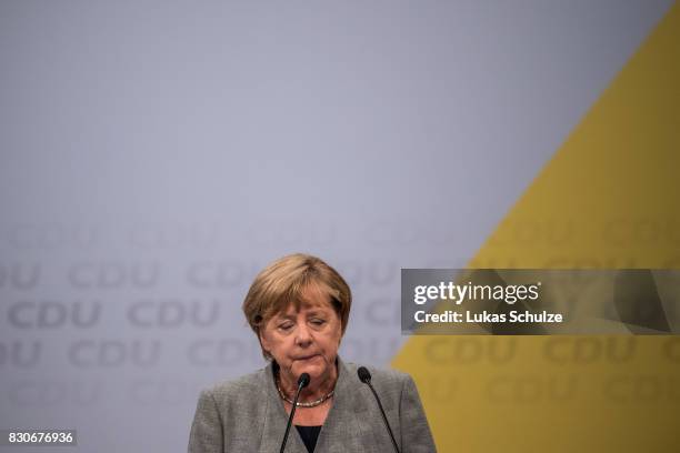 German Chancellor and head of the German Christian Democrats Angela Merkel reacts at the CDU federal election campaign opening rally on August 12,...