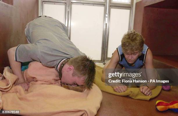 Silver service waiter Gareth Fox from Leytonstone, east London and Toni Allen from Northolt, Middlesex, letting their animal instincts run wild and...