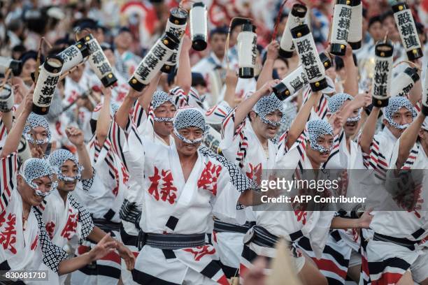 Participants of a "load team" perform during the Awa Odori festival in Tokushima on August 12, 2017. The four-day dance festival attracts more than...