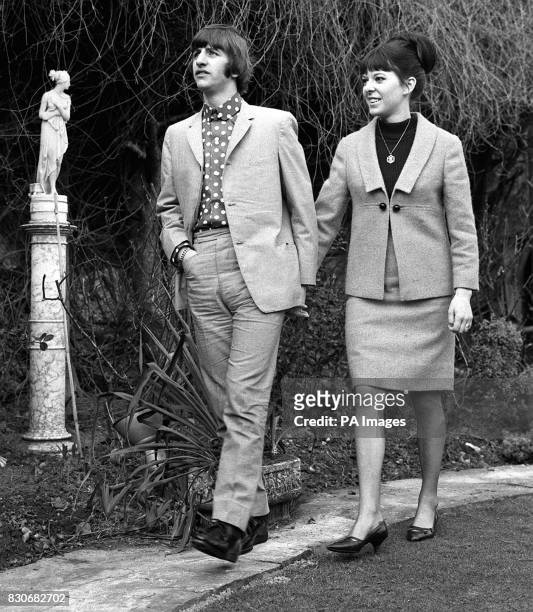 Strolling hand-in-hand are Ringo Starr, the Beatles drummer, and his bride, the former Maureen Cox. They are pictured in the garden of the house in...