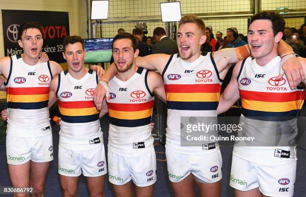 Jake Lever , Rory Atkins, Richard Douglas, Hugh Greenwood and Mitchell McGovern of the Crows sing the song in the rooms after winning the round 21...