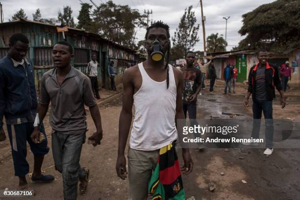 Opposition supporters gather as they clashed against Kenyan police forces in the Kibera slum on August 12, 2017 in Nairobi, Kenya. Demonstrations...