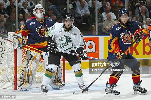 Tucker Hunter of the London Knights sets up between Jaroslav Janus and Tyler Hostetter of the Erie Otters in a game played at the John Labatt Centre...