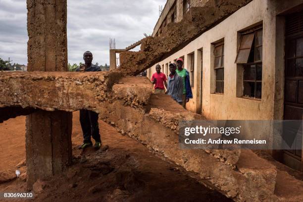 Opposition supporters take cover from Kenyan police forces in the Kibera slum on August 12, 2017 in Nairobi, Kenya. Demonstrations turned violent in...