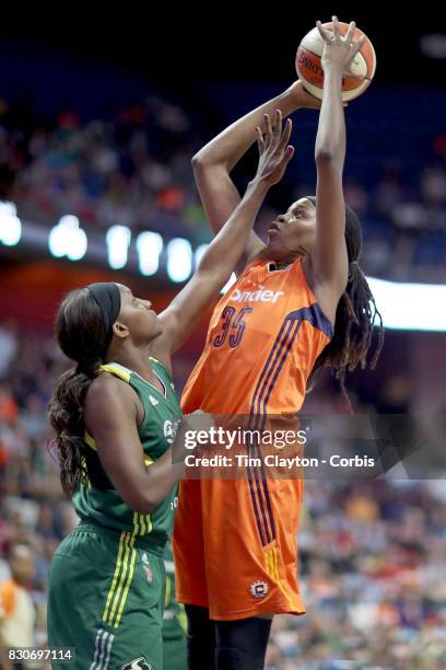 August 8: Jonquel Jones of the Connecticut Sun shoots over forward Crystal Langhorne of the Seattle Storm during the Connecticut Sun Vs Seattle Storm...