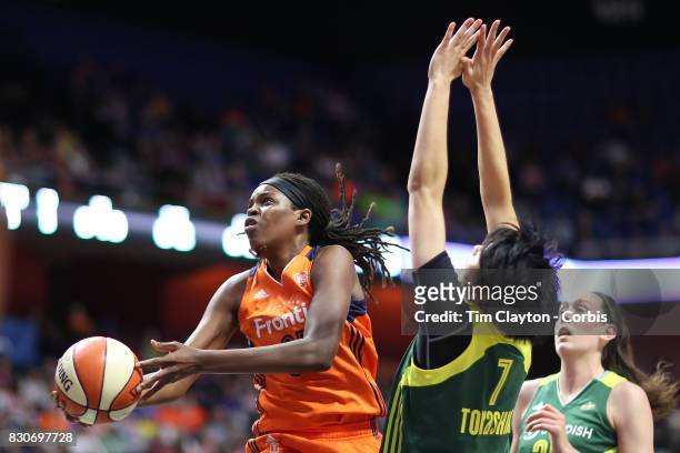 August 8: Jonquel Jones of the Connecticut Sun drives to the basket defended by forward Ramu Tokashiki of the Seattle Storm during the Connecticut...