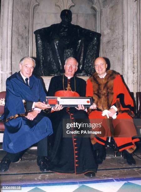 The Archbishop of Westminster, Cardinal Cormac Murphy-O'Connor receiving his official declaration of the Freedom of the City of London, flanked by...