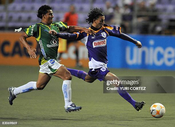 Costa Rican, Michael Barrantes of Saprissa vies for the ball with Erick Norales of Marathon of Honduras during a Concacaf Champions Cup football...