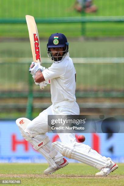 Indian cricketer Shikhar Dhawan plays a shot during the 1st Day's play in the 3rd Test match between Sri Lanka and India at the Pallekele...