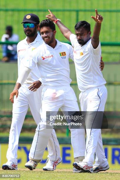 Sri Lankan cricketer Malinda Pushpakumara celebrates with his team mates after taking a wicket during the 1st Day's play in the 3rd Test match...