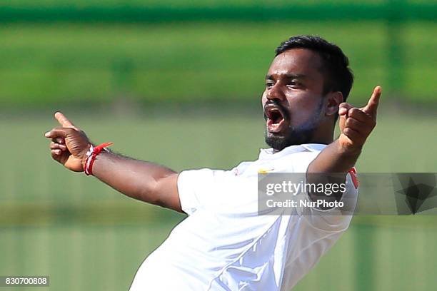 Sri Lankan cricketer Malinda Pushpakumara celebrates the dismissal of Indian batsman Ajinkya Rahane during the 1st Day's play in the 3rd Test match...