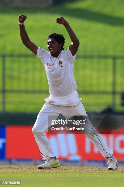 Sri Lankan cricketer Lakshan Sandakan celebrates the dismissal of Indian cricket captain Virat Kohli during the 1st Day's play in the 3rd Test match...