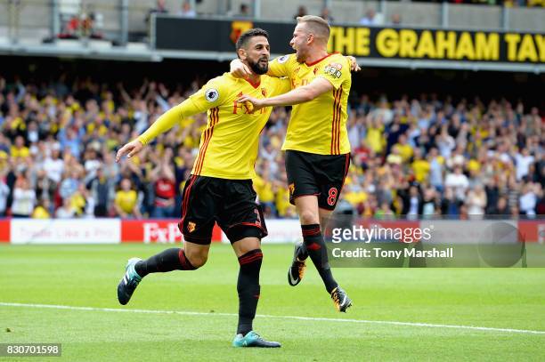 Miguel Britos of Watford celebrates scoring his sides third goal with Tom Cleverley of Watford during the Premier League match between Watford and...