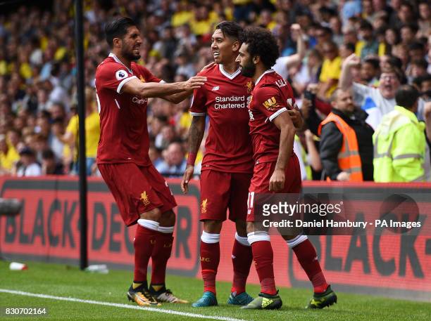 Liverpool's Mohamed Salah celebrates scoring his side's third goal with team-mates Emre Can and Roberto Firmino during the Premier League match at...
