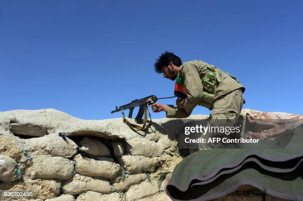 Afghan security forces keep watch near the site of U.S. Airstrike on a civilian vehicle in Haska Mina district Nangarhar province on August 12, 2017....