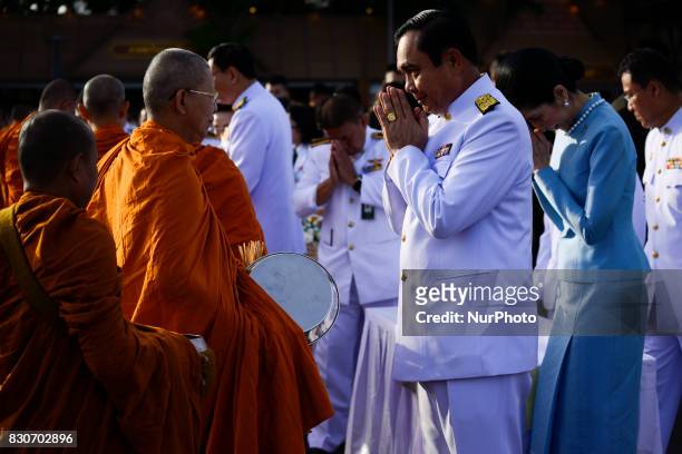 Thai Prime Minister Prayuth Chan-O-Cha gives alms to Buddhist monks to celebrate the Queens Sirikit' 85th birthday in Bangkok, Thailand, 12 August...