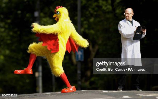 Psychologist Dr Richard Wiseman watches student Peter Costello dressed as a chicken cross the road at the British Association's Festival of Science...