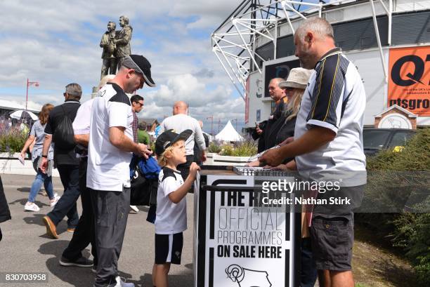 Young Derby fan buys a programme before the Sky Bet Championship match between Derby County and Wolverhampton at iPro Stadium on August 12, 2017 in...