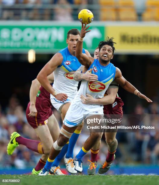 Aaron Hall of the Suns is tackled by Dayne Beams of the Lions during the 2017 AFL round 21 match between the Brisbane Lions and the Gold Coast Suns...